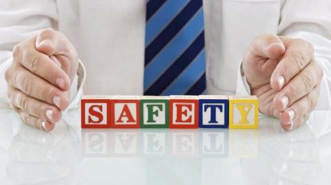 Hands either side of blocks spelling out safety.